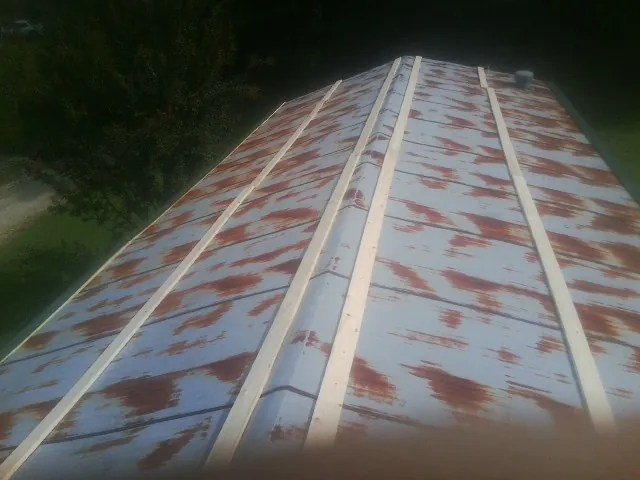 Rusted metal roof panels with new wood purlins before replacement — Storm Damage Roof Repair in Jbsa Randolph by Roofing Brothers